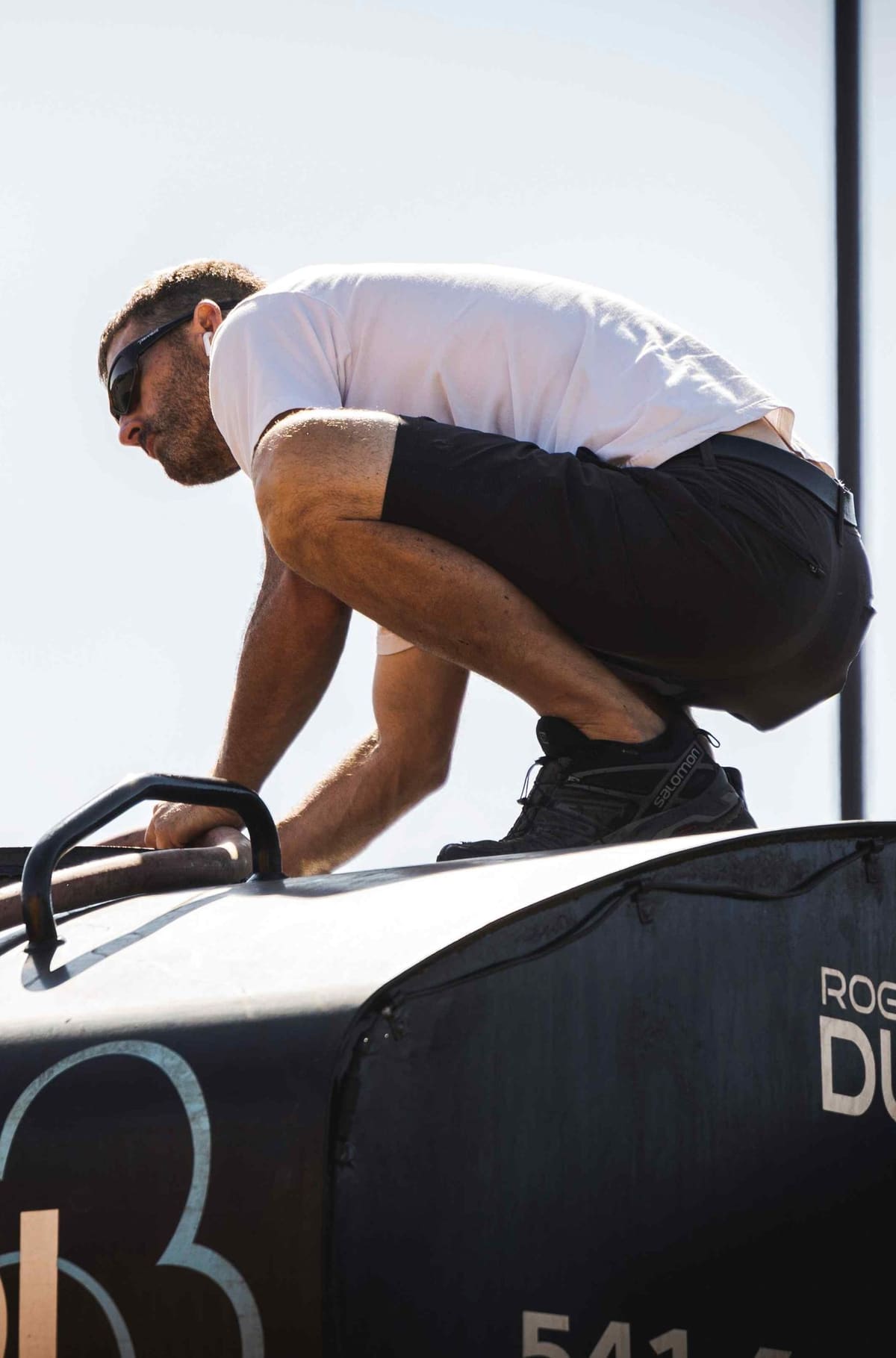 A Rogue Dust Control crew member working on top of the tank.